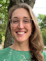 image of a woman with long blonde hair glasses and green shirt